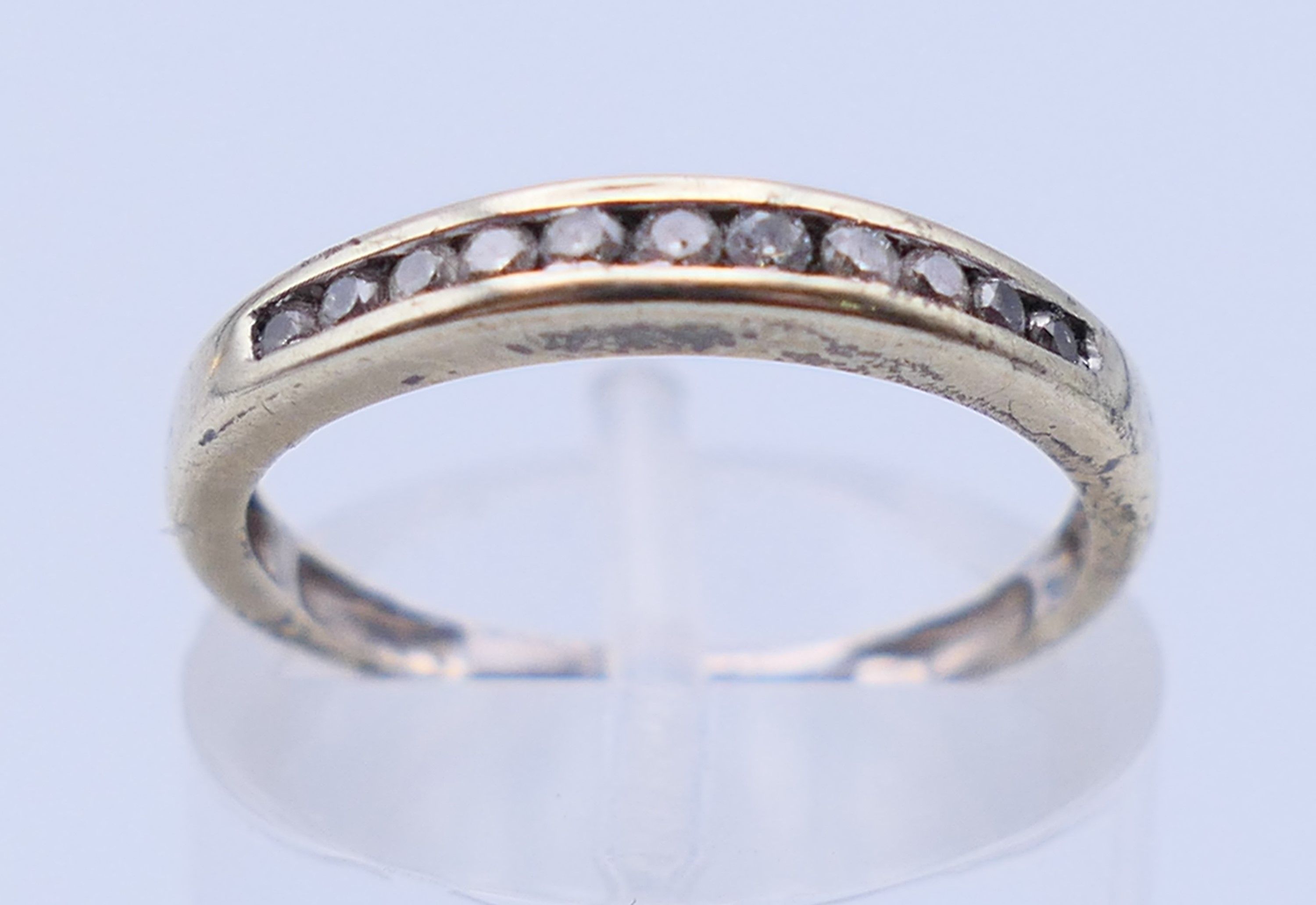 A 9 ct gold three-stone ring and an unmarked half hoop eternity ring. The former, Ring size M and 3. - Image 3 of 11