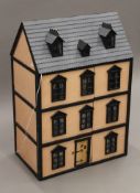 A Victorian-style dolls' house including some furnishings. 61 cm wide x 88 cm high.