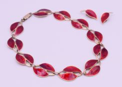 A Meka Danish red enamel and silver necklace and a pair of matching earrings.