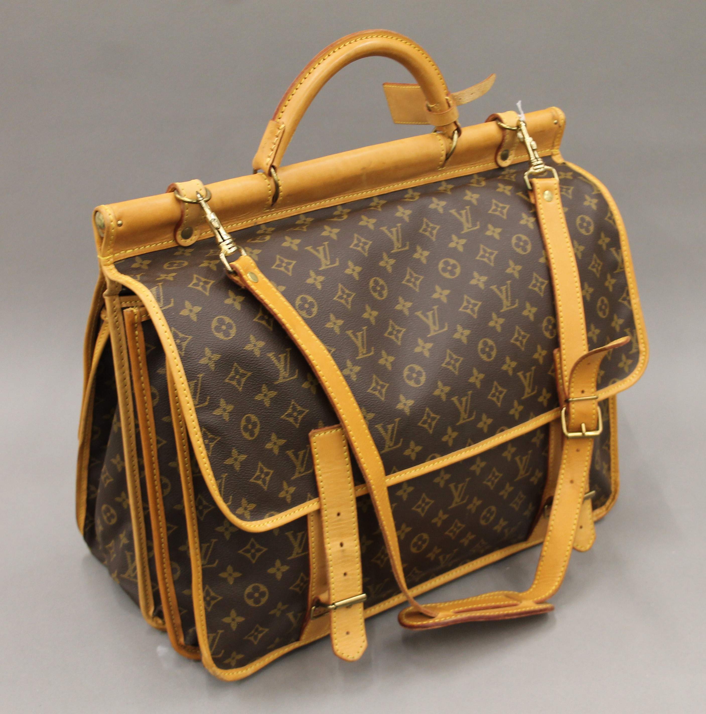 A vintage 1980's Louis Vuitton three-pocket travel bag with leather trim and shoulder strap. - Image 6 of 16