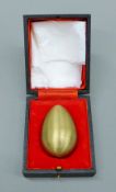 A boxed Stuart Devlin silver gilt egg enclosing Little Jack Horner. 7 cm high. 132.
