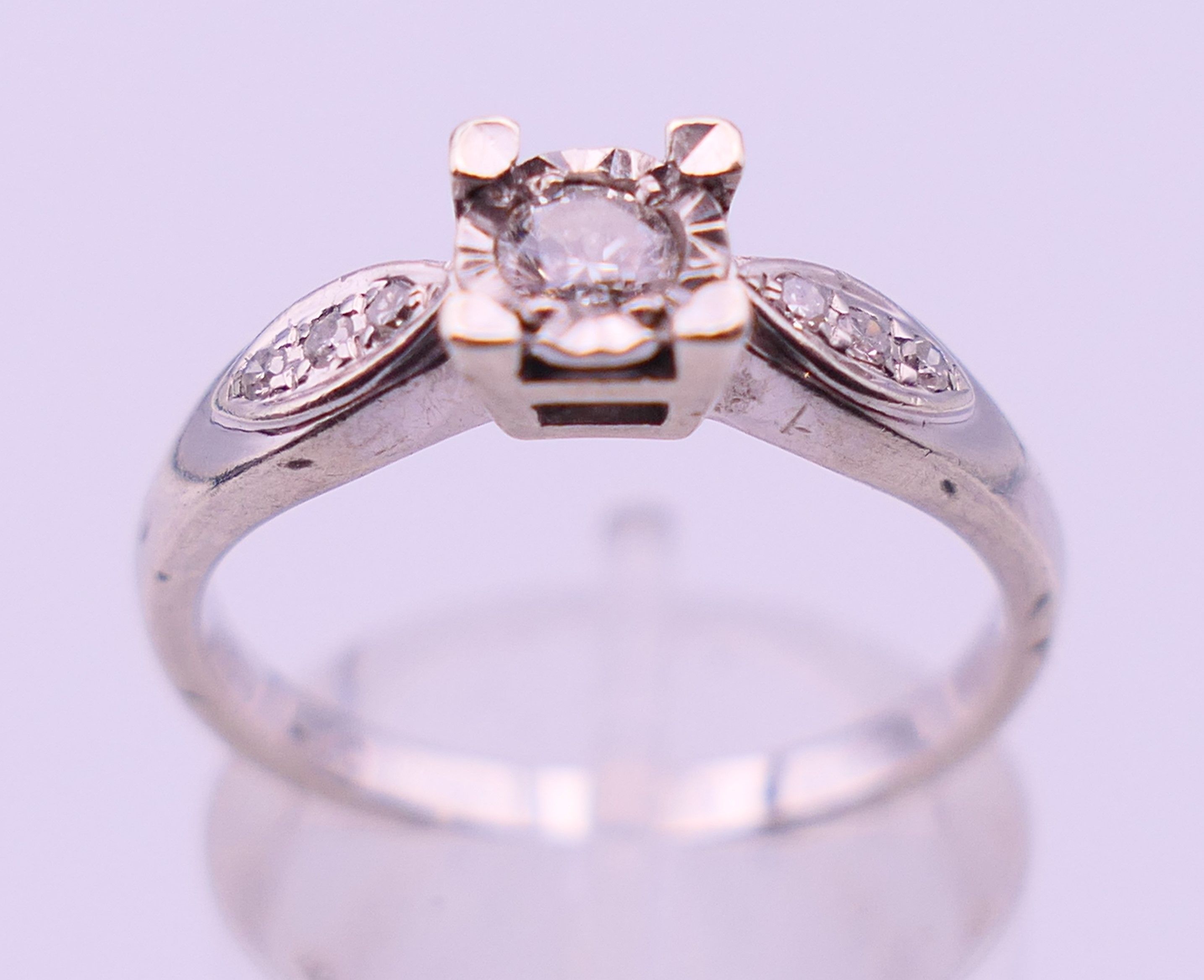 A 9 ct white gold and 0.20 carat diamond ring. Ring size N/O. 2.9 grammes total weight. - Image 2 of 5