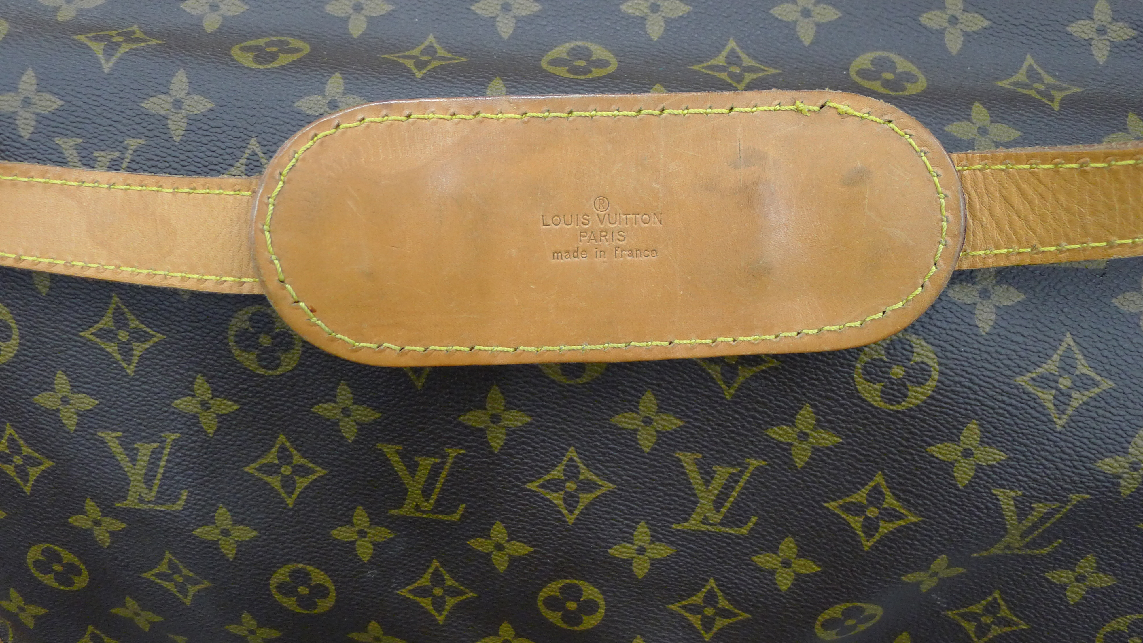A vintage 1980's Louis Vuitton three-pocket travel bag with leather trim and shoulder strap. - Image 16 of 16