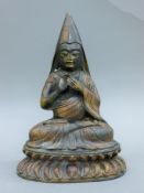 A bronze figure of Buddha seated. 28 cm high.