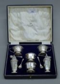 A cased silver six-piece cruet set. The case 22.5 cm wide. 237.7 grammes.