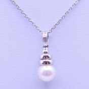 An 18 ct white gold, diamond and pearl drop pendant on a chain. Pendant 2.