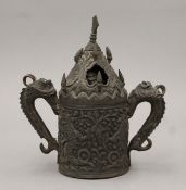 An antique Tibetan embossed metal incense burner. 17 cm high.