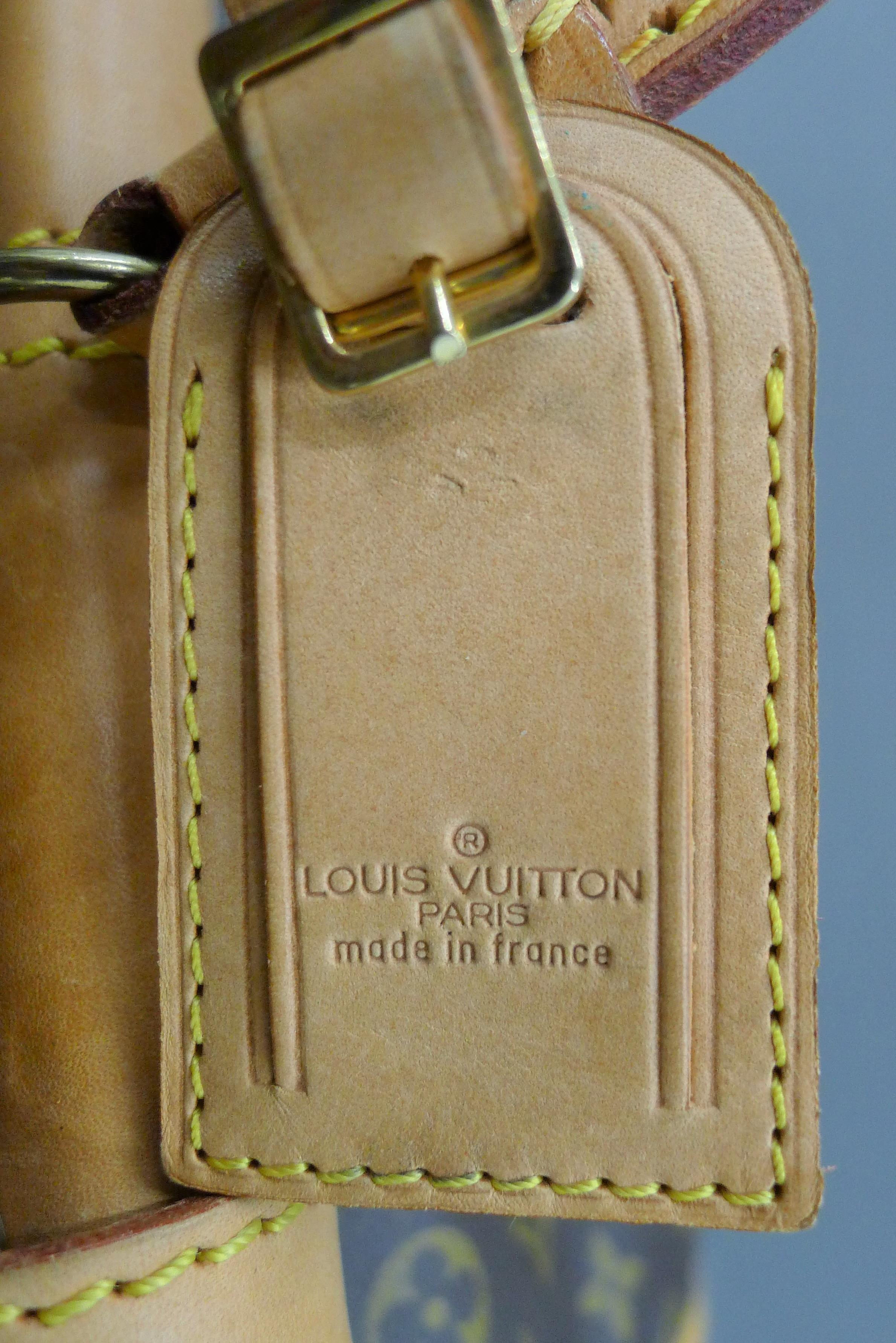 A vintage 1980's Louis Vuitton three-pocket travel bag with leather trim and shoulder strap. - Image 14 of 16