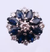 An 18 ct white gold, diamond and sapphire cluster ring. Ring size P/Q.
