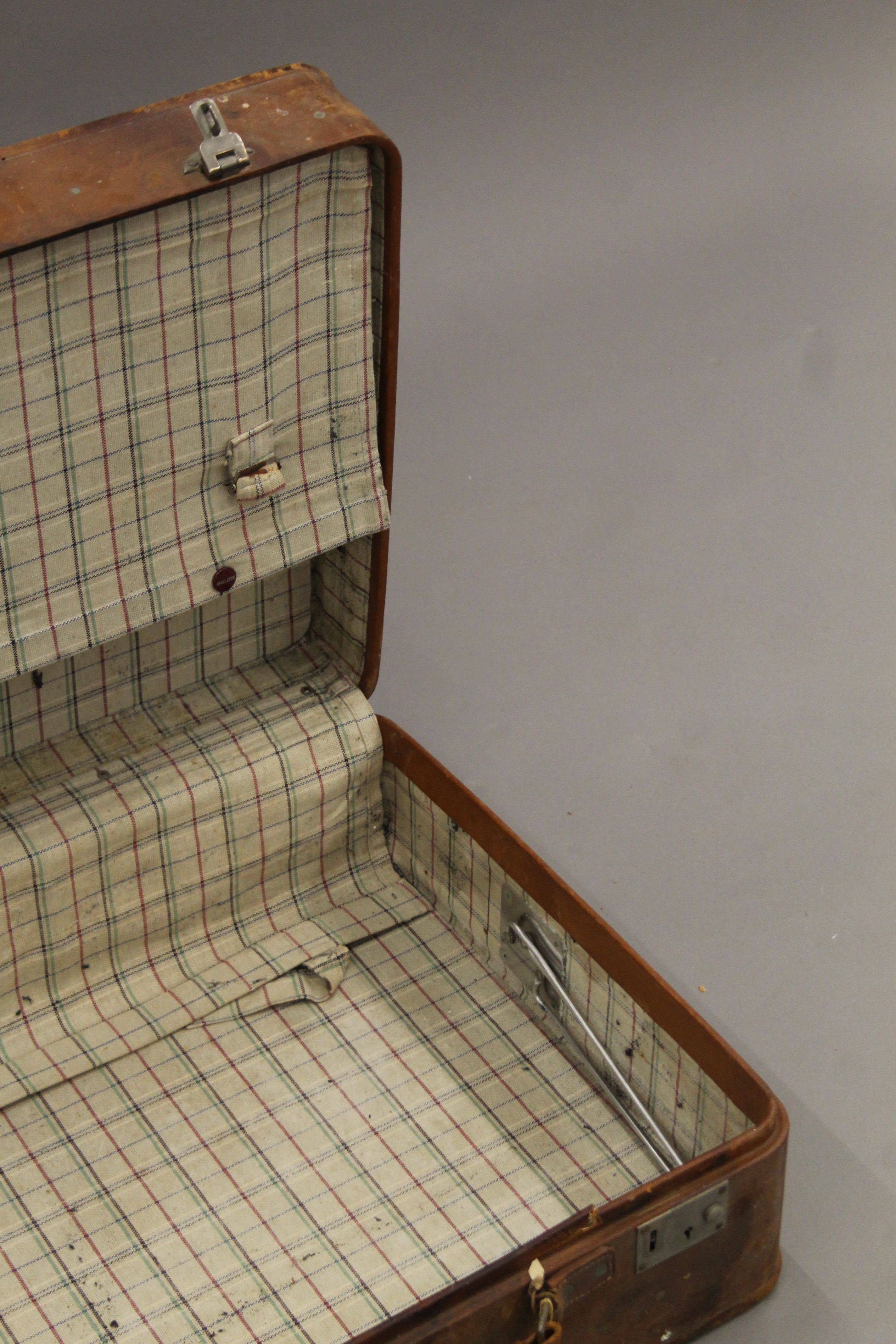 A vintage leather suitcase with some old travel labels. 55 cm wide. - Image 6 of 7