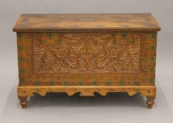 An Eastern brass inlaid carved hardwood trunk. 111 cm long.