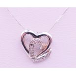 A 9 ct white gold and diamond double heat pendant on a 9 ct white gold chain. Pendant 1.