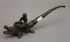 An African bronze pipe formed as a monkey riding a crocodile 24.5 cm long.