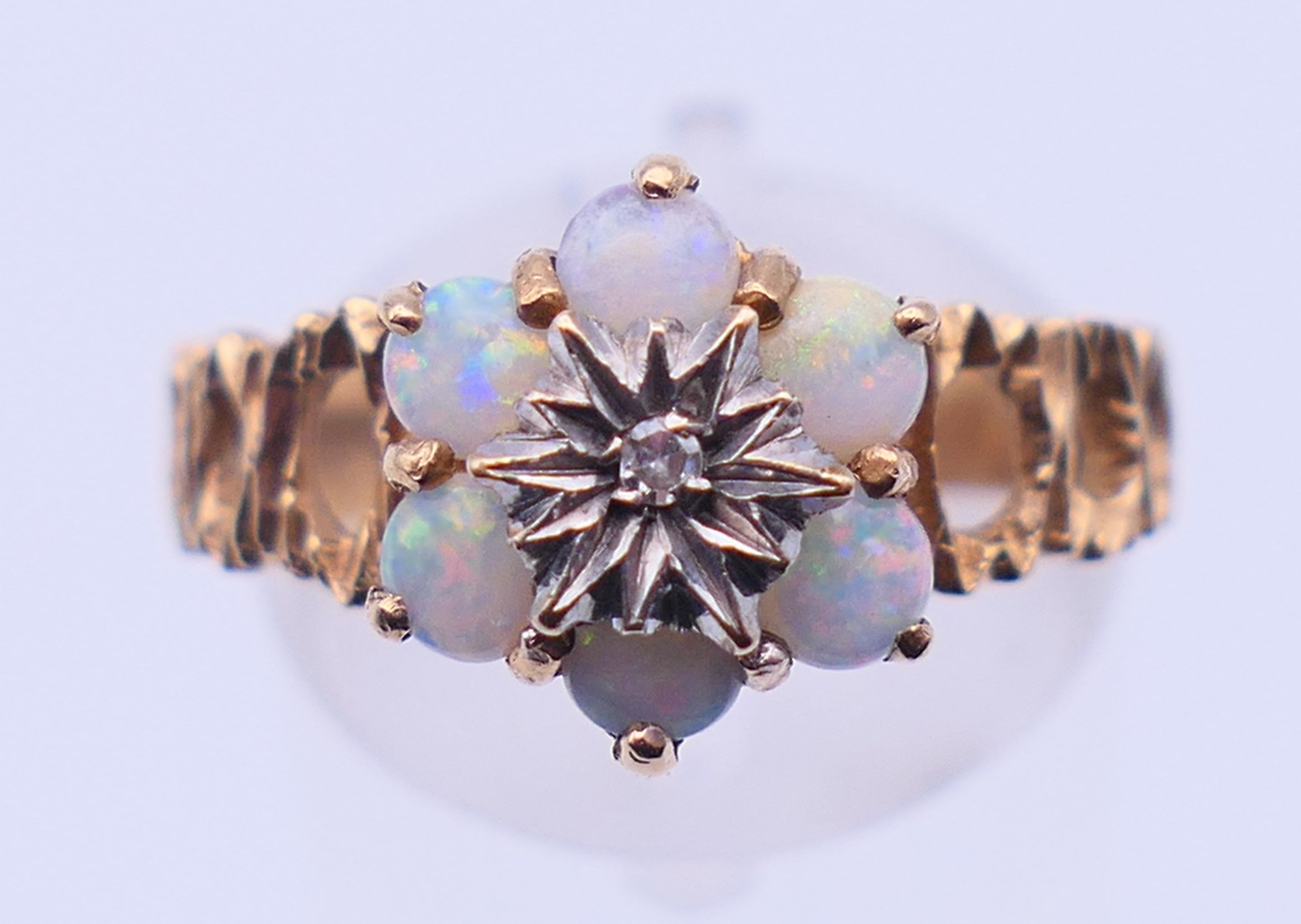 A 9 ct gold, diamond and opal ring. Ring size P/Q. 3.3 grammes.