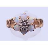 A 9 ct gold, diamond and opal ring. Ring size P/Q. 3.3 grammes.