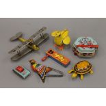 A quantity of vintage tin plate toys and a wooden bi-plane. The latter 22 cm wide.