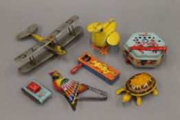 A quantity of vintage tin plate toys and a wooden bi-plane. The latter 22 cm wide.