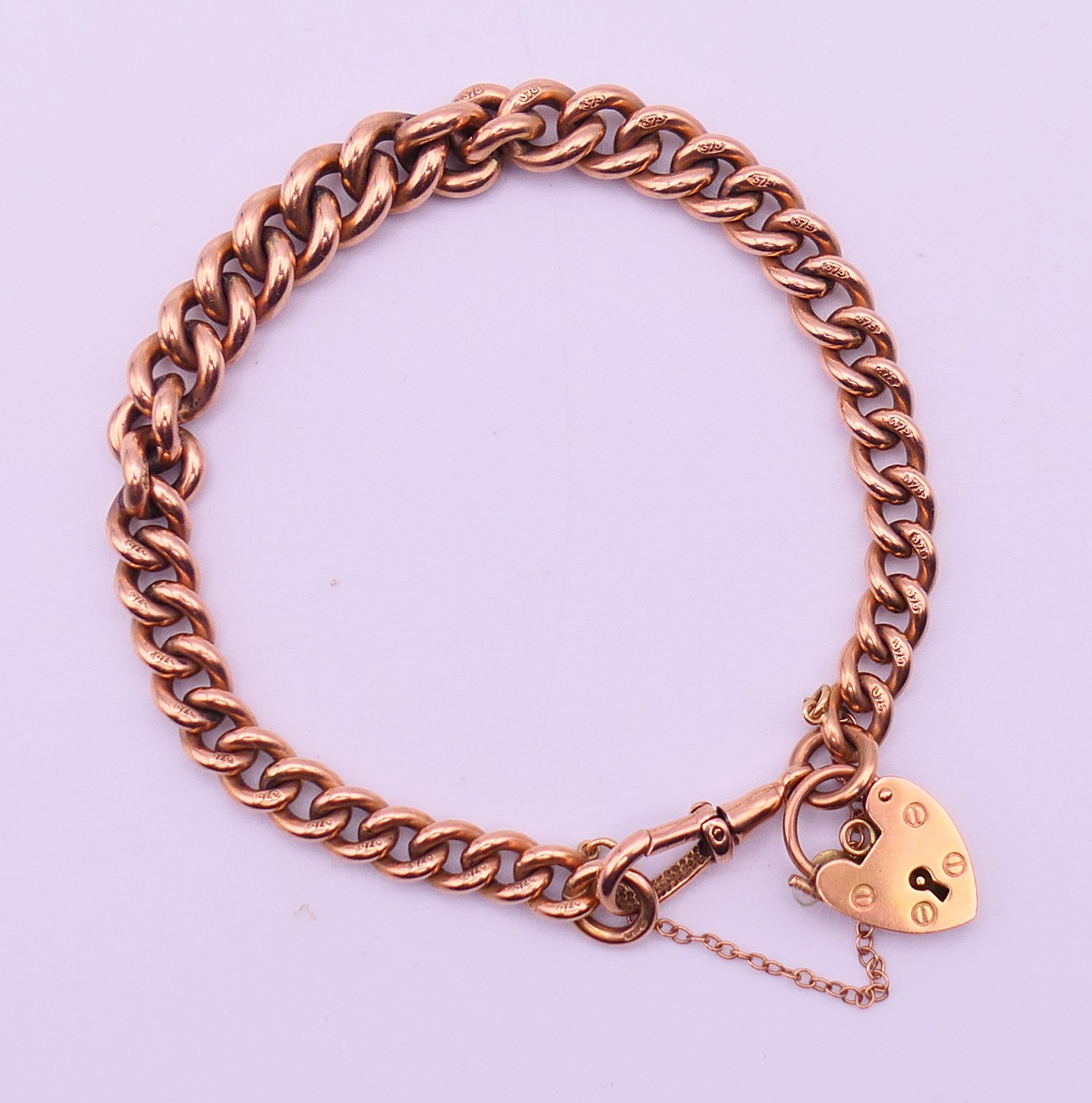 A 9 ct gold bracelet with padlock fastening. 19 cm long. 27.5 grammes. - Image 4 of 5