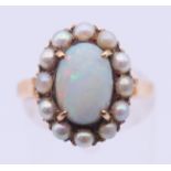 An unmarked gold, opal and seed pearl ring. Ring size M/N. 4 grammes total weight.