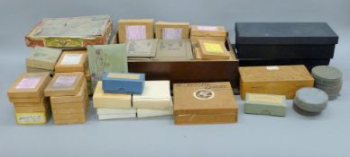 Three boxes of photographic plates and microscope slides.