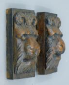 A pair of mounted antique carved oak lion masks. Each 15 cm high overall.