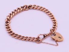 A 9 ct gold bracelet with padlock fastening. 19 cm long. 27.5 grammes.