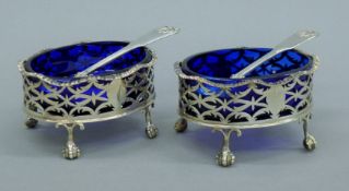 A pair of 1908 silver salts and a pair of 1832 silver salt spoons. The former each 9 cm long.