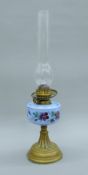 A Victorian brass and painted glass oil lamp. 31 cm high excluding chimney.