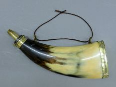 A 19th century European horn and brass powder flask. 23 cm long.