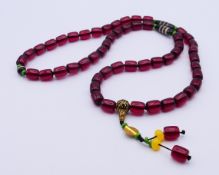 A string of beads. 84 cm long.