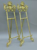 A pair of brass table easels. Each 77 cm high.