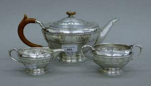 A Liberty & Co silver three-piece tea set. The teapot 27 cm long. 831.4 grammes total weight.