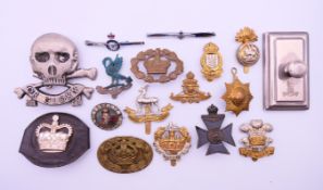 Various cap badges, a buckle a paper weight etc. Paper weight 8.5 cm long.