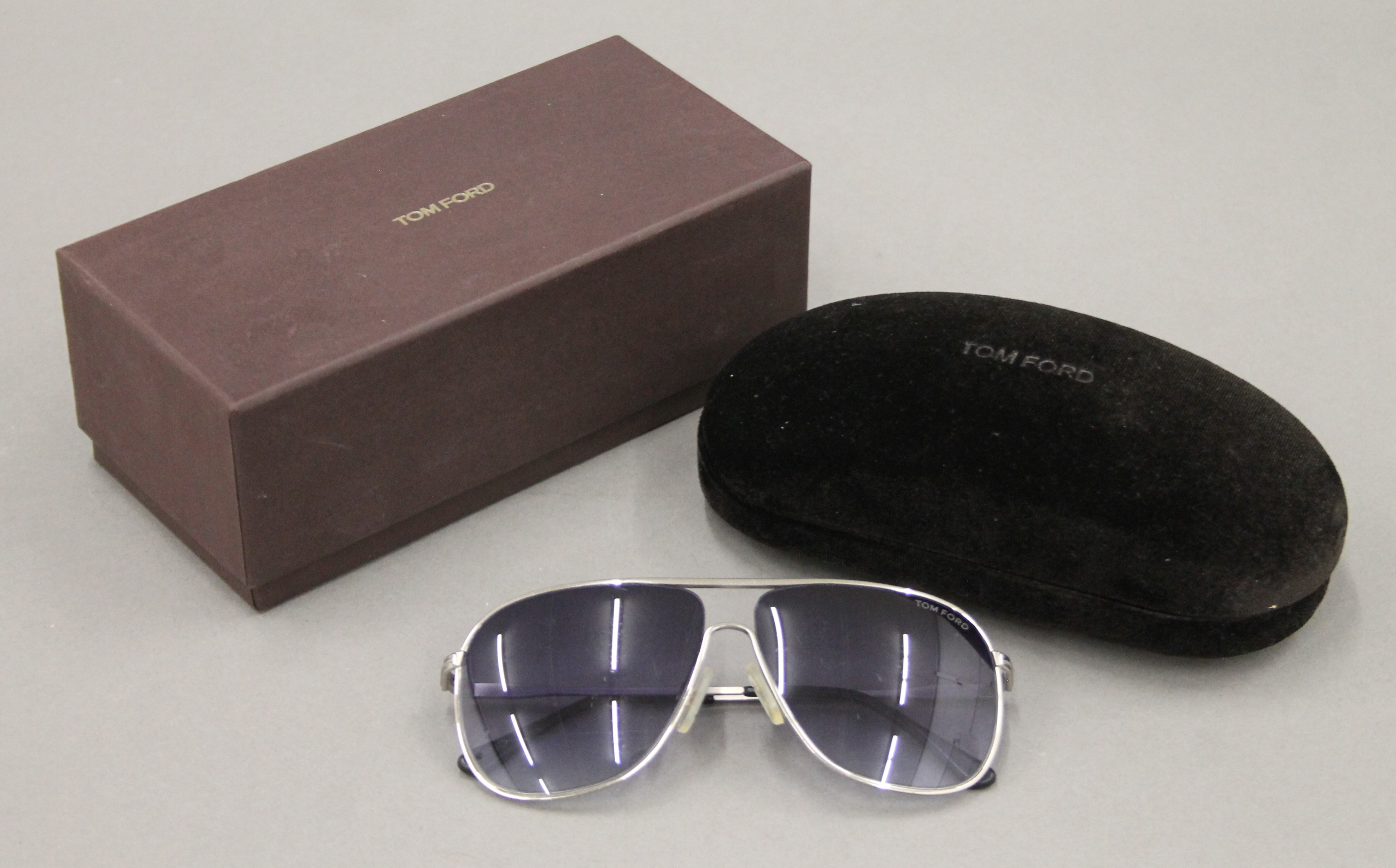 A boxed pair of Tom Ford sunglasses. The box 18 cm wide.