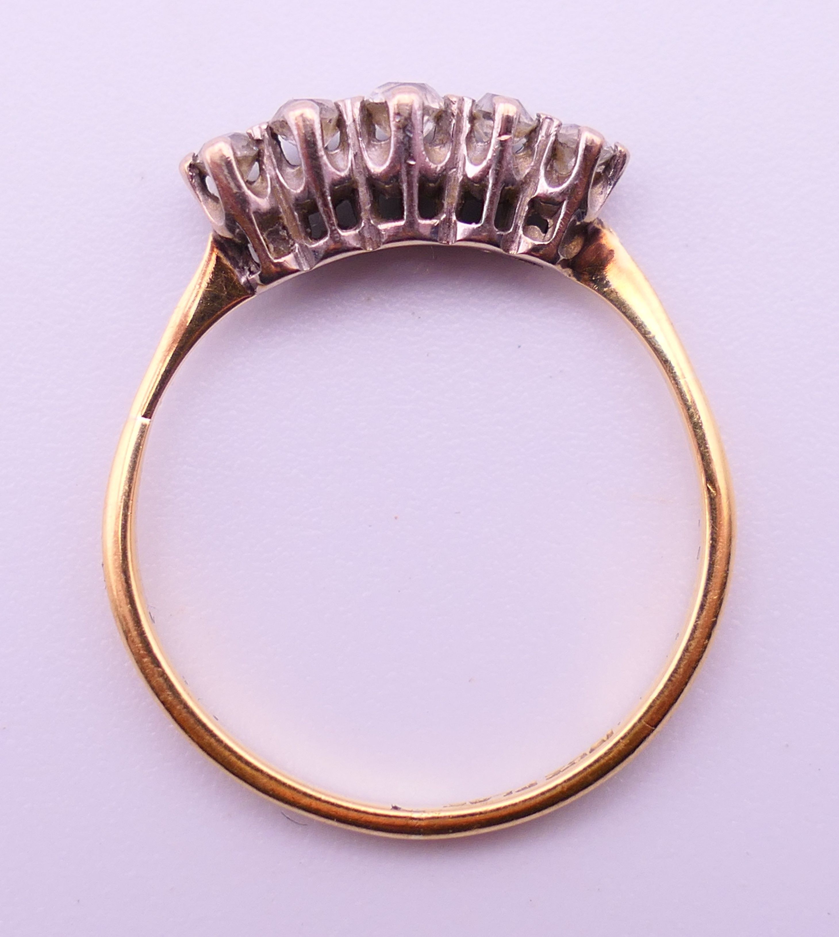 An 18 ct gold and platinum five-stone diamond ring. Ring size N/O. 2.1 grammes total weight. - Image 5 of 5