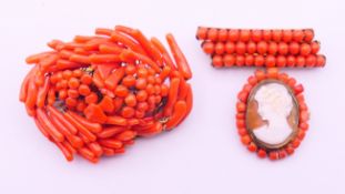 Two coral brooches. The larger 5 cm wide.