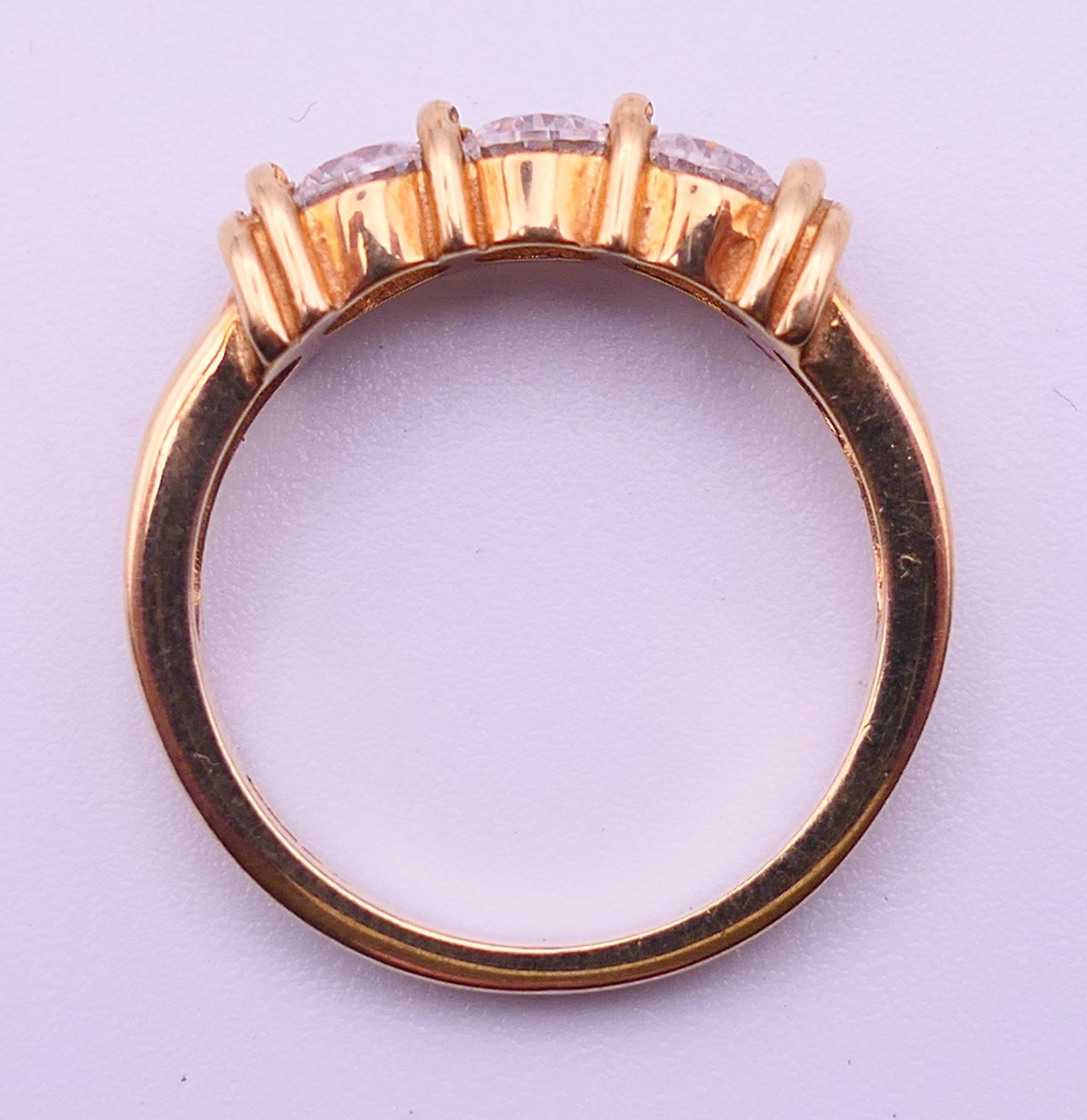A 9 ct gold three-stone ring and an unmarked half hoop eternity ring. The former, Ring size M and 3. - Image 11 of 11