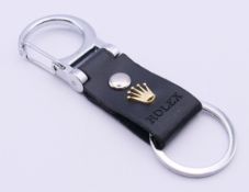 A new Rolex keyring, boxed. 9 cm high.