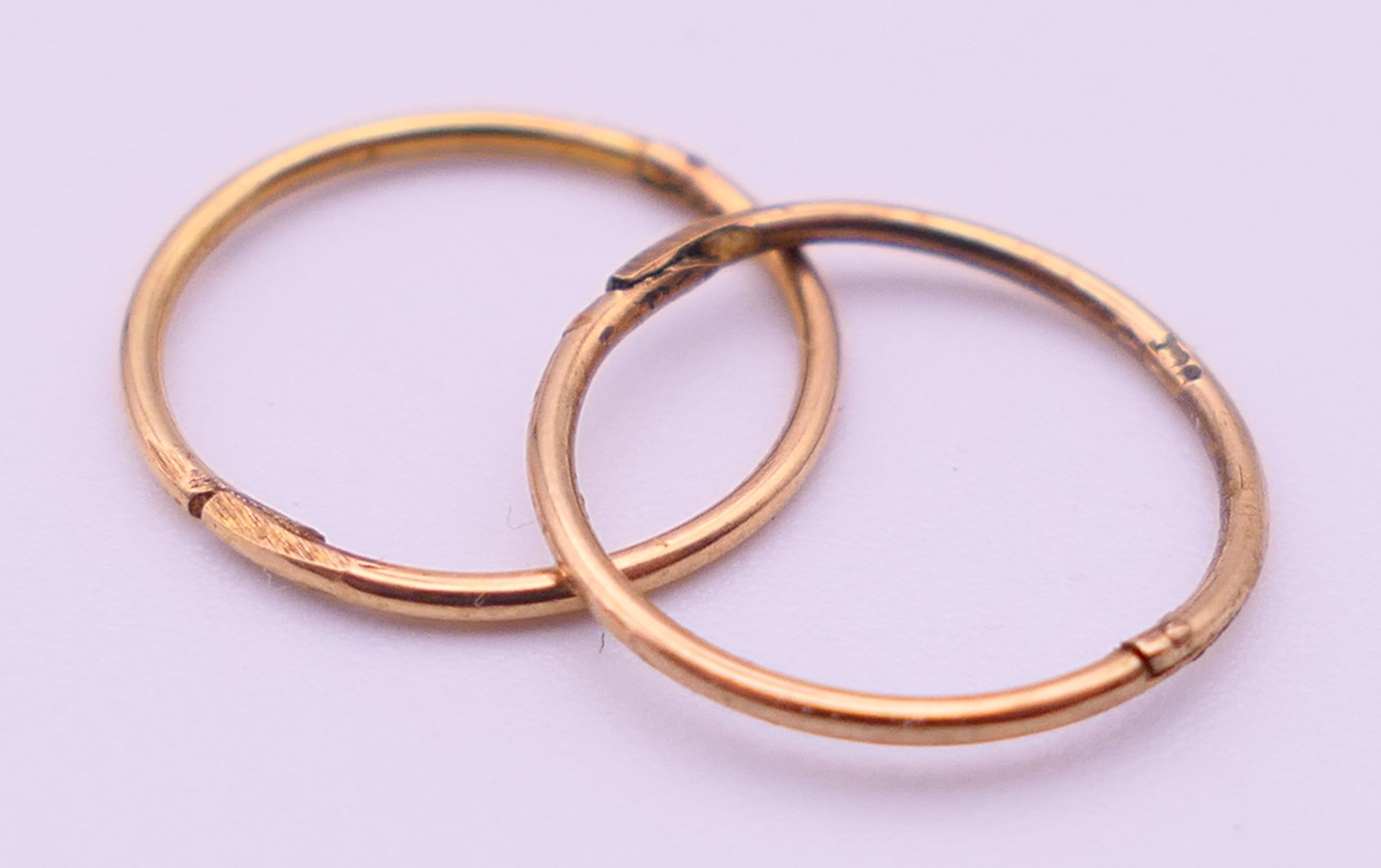 Two 9 ct gold rings, an unmarked gold signet ring and a pair of 9ct gold hoop earrings. - Image 18 of 19