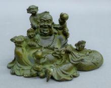 A bronze Buddha with children. 10.5 cm wide.