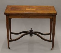 A Victorian inlaid rosewood card table. 89 cm wide.