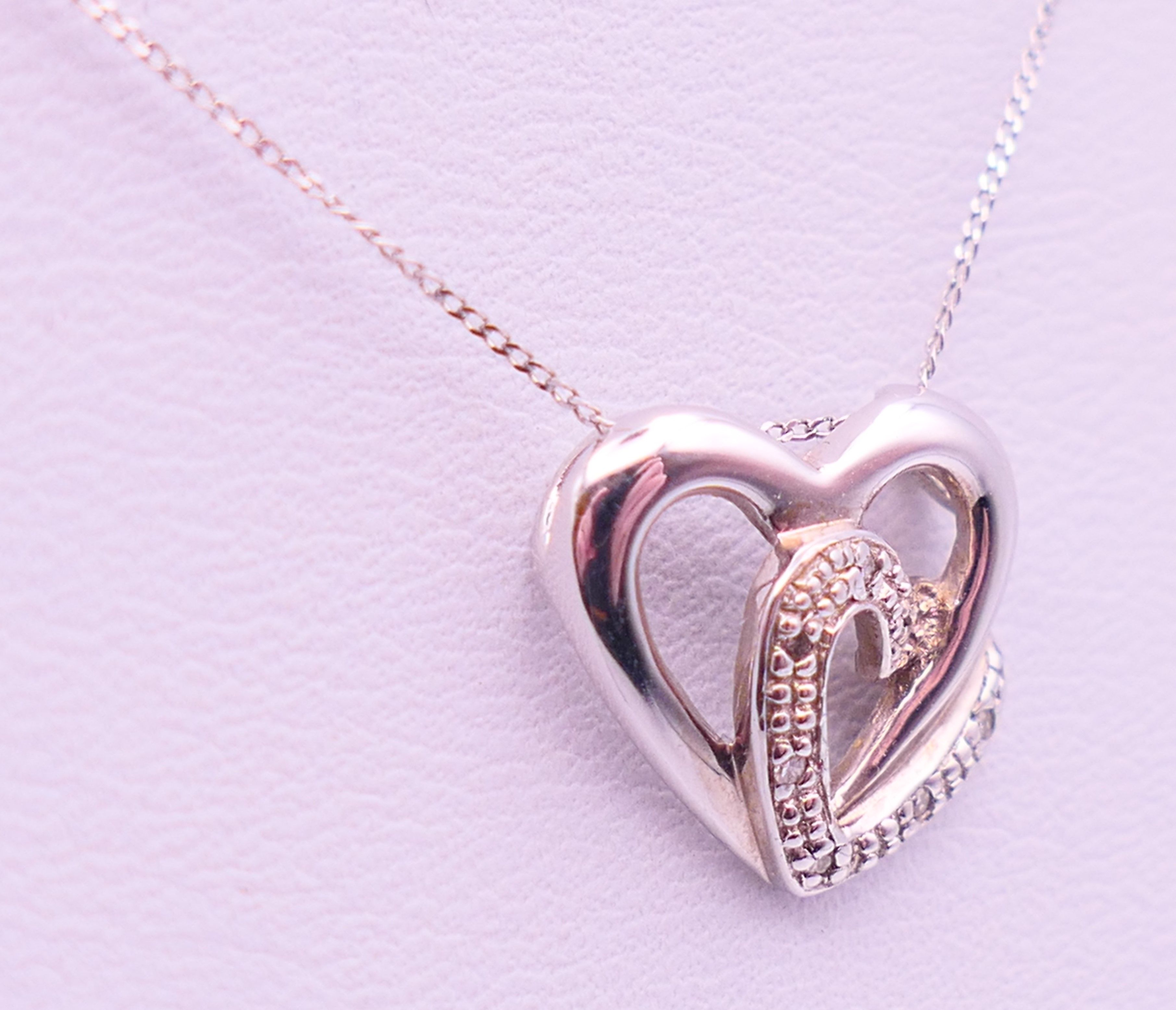 A 9 ct white gold and diamond double heat pendant on a 9 ct white gold chain. Pendant 1. - Image 2 of 8