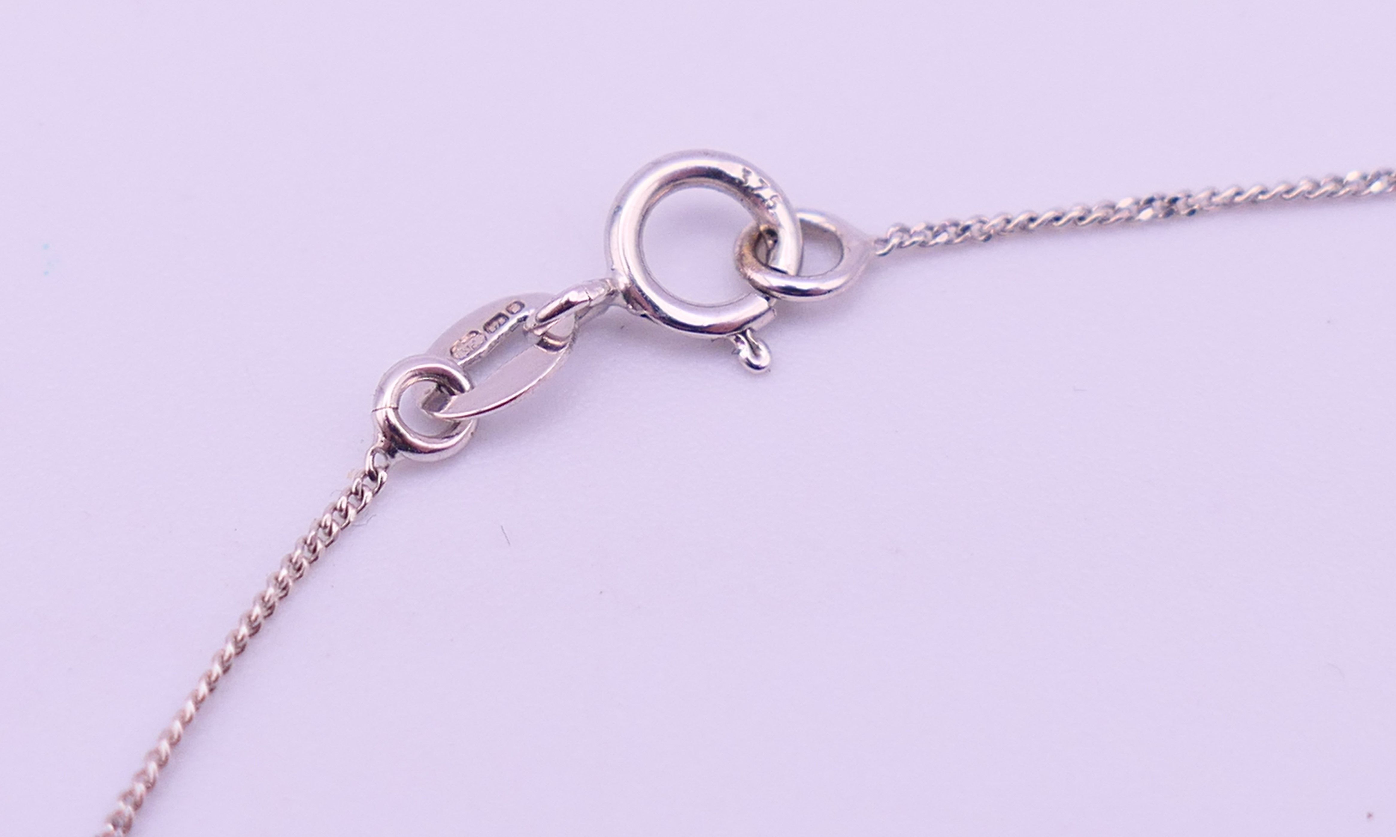 A 9 ct white gold and diamond pendant necklace. Pendant drop 3 cm high, chain 45 cm long. 3. - Image 6 of 8