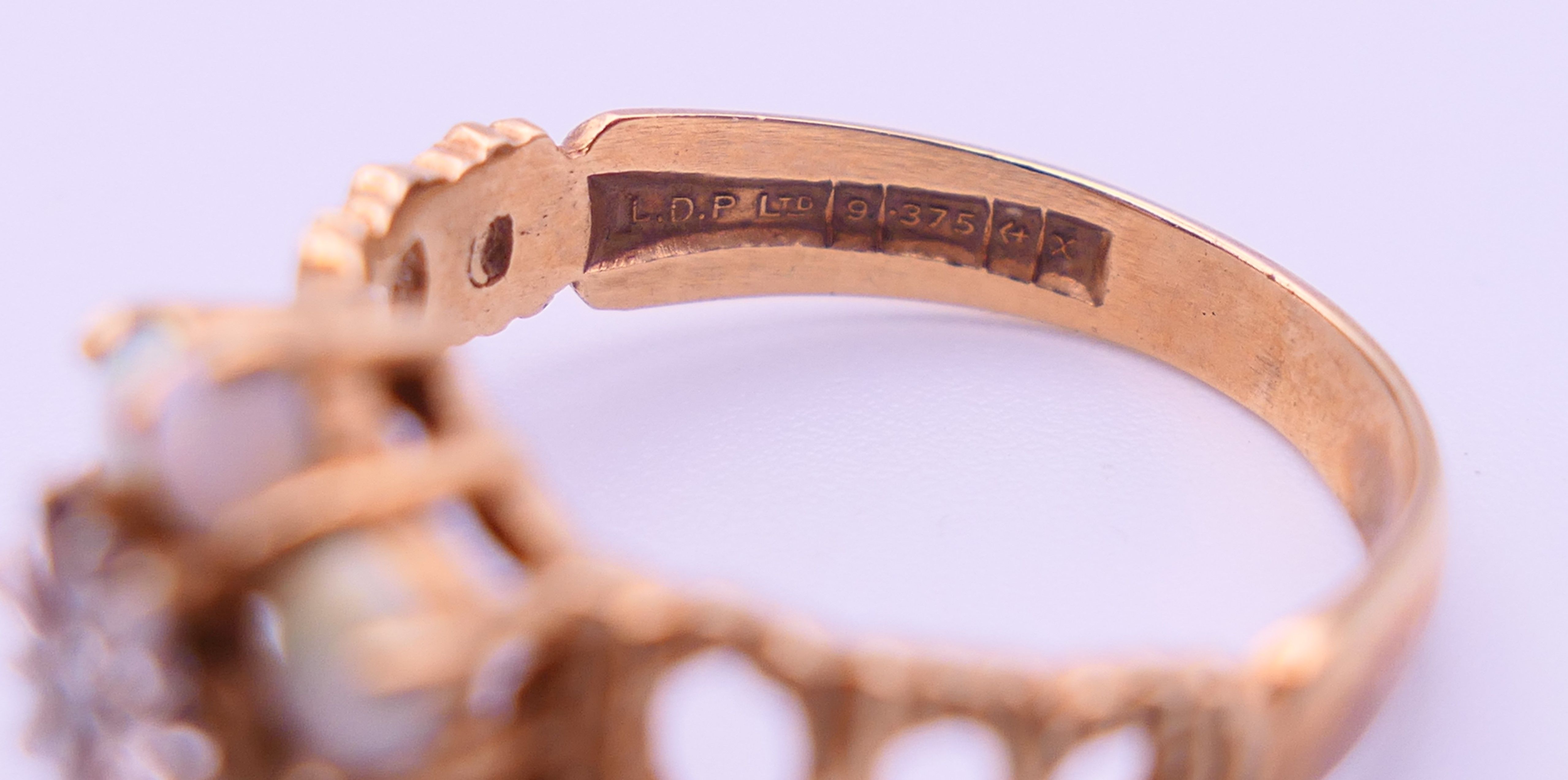 A 9 ct gold, diamond and opal ring. Ring size P/Q. 3.3 grammes. - Image 4 of 5