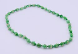 A string of jade beads. 58 cm long.