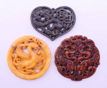 Three Chinese stone discs. The largest 7 cm diameter.