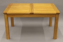 A modern oak single leaf extending dining table.