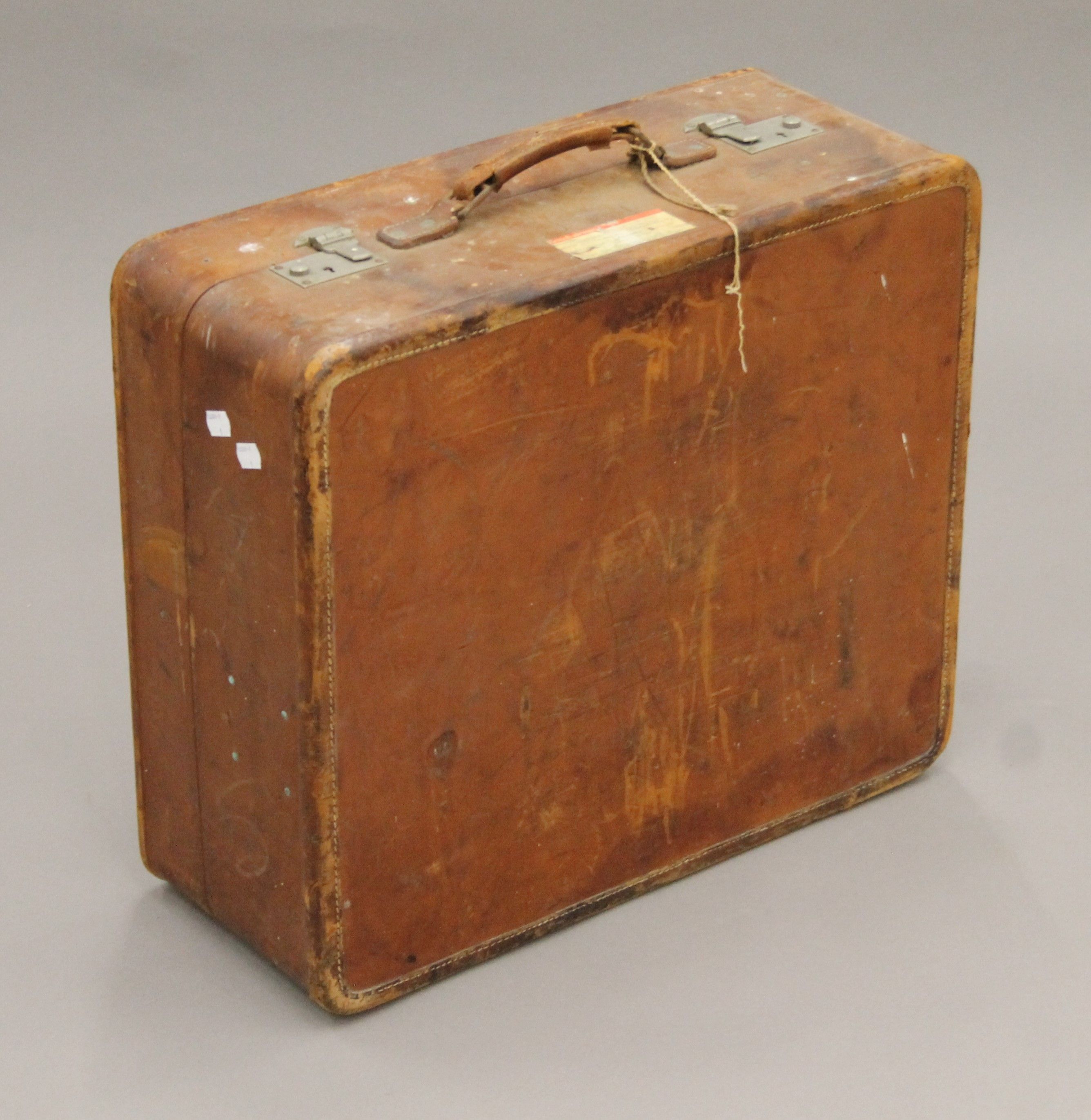 A vintage leather suitcase with some old travel labels. 55 cm wide. - Image 2 of 7