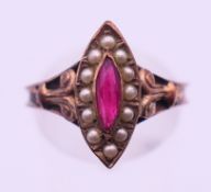 An antique 8 ct gold, seed pearl and ruby ring. Ring size S. 1.3 grammes total weight.