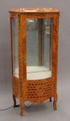 A Serpentine-fronted display cabinet. 144 cm high x 66 cm wide.